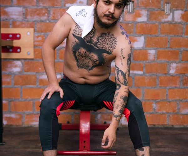 Man focus during isometric strength exercise in a minimal gym